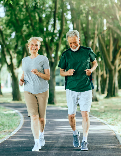 Active senior couple running outdoors